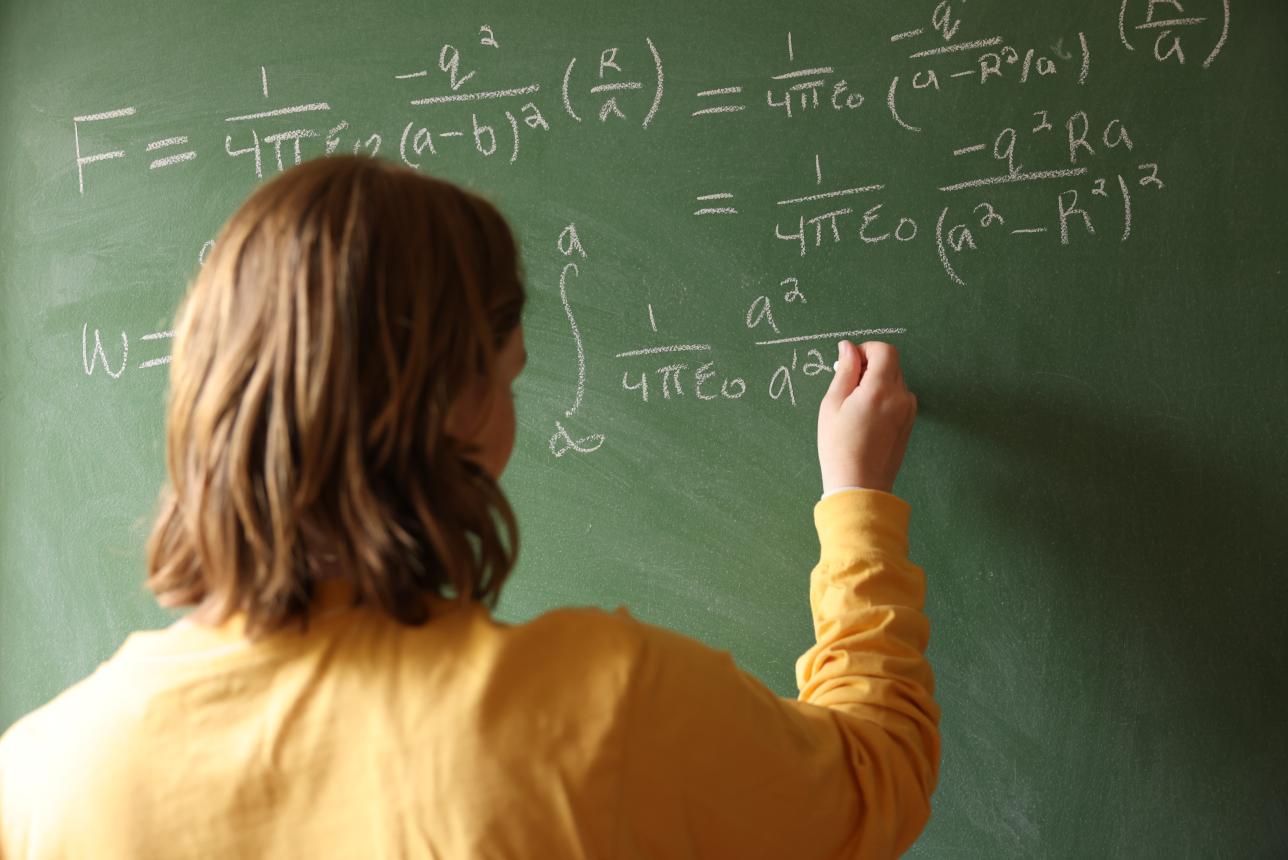 William & Mary Mathematics major solving a problem on the chalkboard